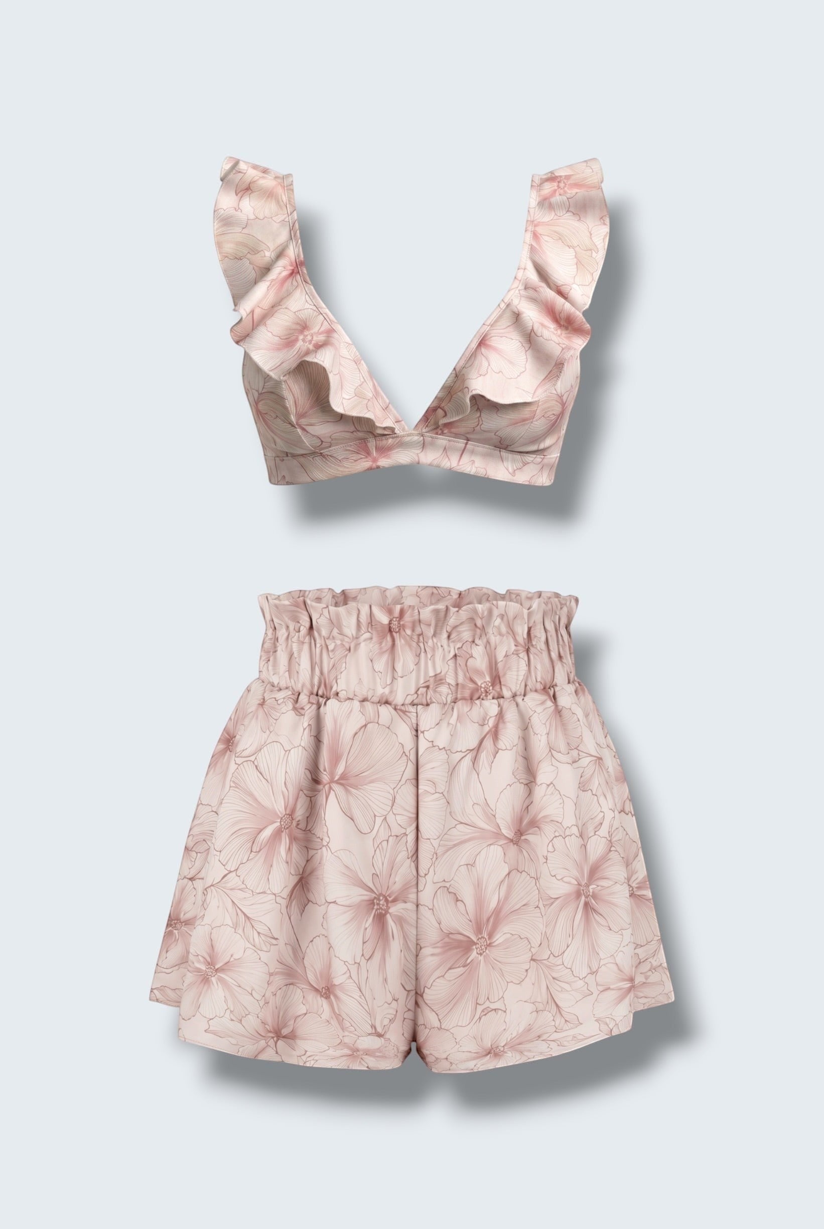 The Saint 54 pink floral two-piece set featuring a ruffled bralette top and high-waisted flared mini shorts.