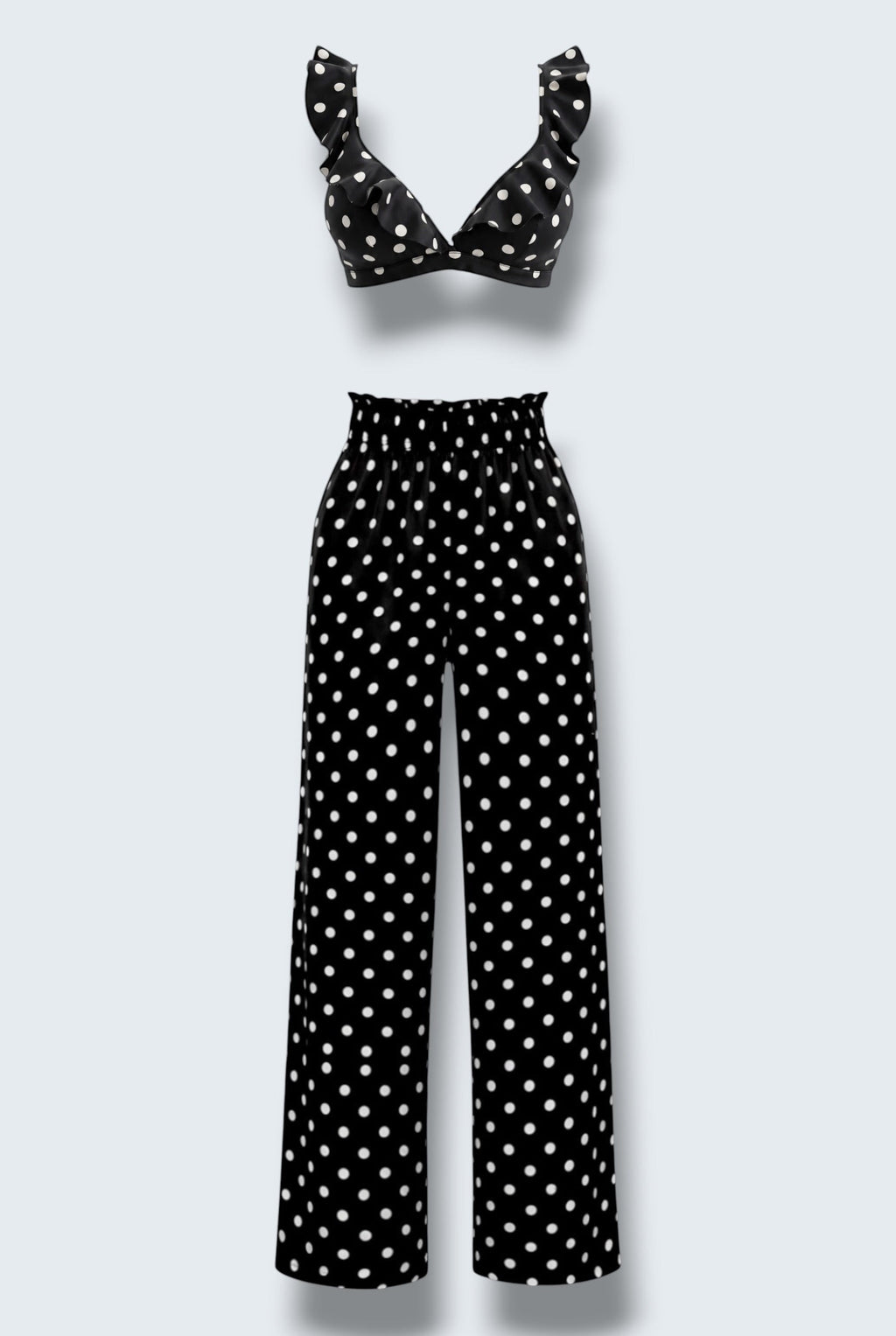 The Saint 54 black and white polka dot two-piece set featuring a ruffled crop top and high-waisted wide-leg trousers.