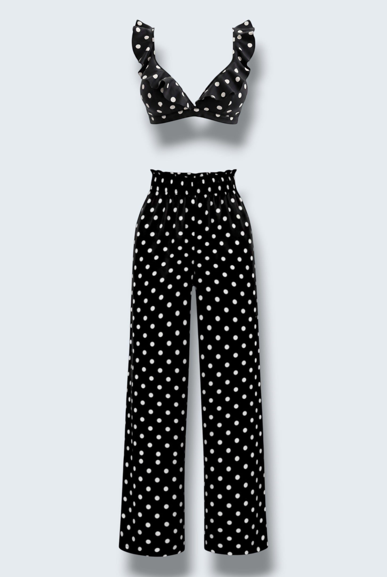 The Saint 54 black and white polka dot two-piece set featuring a ruffled crop top and high-waisted wide-leg trousers.